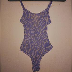 Skims lilac swirl bodysuit thong back, snap on bottom, size very stretchy NWT